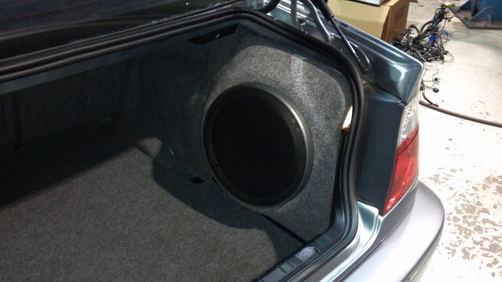 kenwood sub loaded in new fiberglass enclosure that fits nice and neat in the corner of the trunk so you don't have to sacrifice and trunk space to get great sounding bass