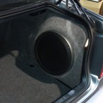 kenwood sub loaded in new fiberglass enclosure that fits nice and neat in the corner of the trunk so you don't have to sacrifice and trunk space to get great sounding bass